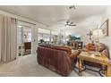 Cozy living room with leather sofas and a view of the backyard at 10631 W Brookside Dr, Sun City, AZ 85351