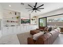 Living room boasts a brown sectional sofa and built-in shelving at 10713 E Hawk Ave, Mesa, AZ 85212