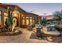 Elegant entryway with arched doorway and stone accents at 14179 E Kalil Dr, Scottsdale, AZ 85259