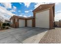 View of the home's exterior, including a large three-car garage at 14353 W Ventura St, Surprise, AZ 85379