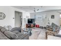 Living room with comfortable seating and a large TV at 16224 W La Ventilla Way, Goodyear, AZ 85338