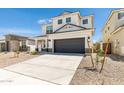 Two-story house with a dark gray garage door and landscaping at 17826 W Sanna St, Waddell, AZ 85355