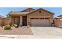 Single-story house with a two-car garage and nicely landscaped yard at 1825 N Lewis Pl, Casa Grande, AZ 85122