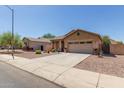 Single-story house with a two-car garage and desert landscaping at 1825 N Lewis Pl, Casa Grande, AZ 85122