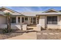 House entrance with brick facade and a security door at 18606 N Iona Ct, Sun City West, AZ 85375