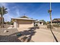 Front view of a house with a two-car garage and gravel driveway at 18606 N Iona Ct, Sun City West, AZ 85375