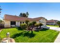 House exterior showcasing a well-maintained lawn and attractive landscaping at 19037 N 73Rd Ln, Glendale, AZ 85308