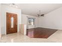 Living room with hardwood floors, high ceilings, and a ceiling fan at 19037 N 73Rd Ln, Glendale, AZ 85308