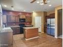 Kitchen with stainless steel appliances and island at 20356 N 261St Dr, Buckeye, AZ 85396