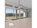 Living room with backyard view through sliding glass doors and transom windows at 21537 W Pierson St, Buckeye, AZ 85396