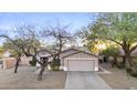 Inviting single-story home with mature trees, low-maintenance landscaping, and a two-car garage at 2171 S Portland Ave, Gilbert, AZ 85295