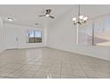 Bright, open living room featuring neutral walls, tile flooring, and a ceiling fan at 2171 S Portland Ave, Gilbert, AZ 85295