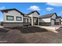 Craftsman style home with stone accents and a two-car garage at 23527 W Estes Way, Buckeye, AZ 85326