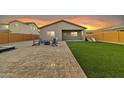 Artificial turf backyard with firepit and patio at 2562 N Abbey Rd, Casa Grande, AZ 85122