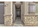 Front entry with stone accents and a dark brown door at 2562 N Abbey Rd, Casa Grande, AZ 85122