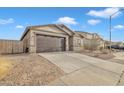 Single story home with a two-car garage, and desert landscaping at 2562 N Abbey Rd, Casa Grande, AZ 85122