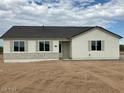 Newly built single-story home with light-colored exterior and stone accents at 25835 W Denver Hills Dr, Wittmann, AZ 85361