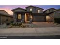 Stunning two-story home with stone exterior, landscaped yard, and attached garage at 26698 N 104Th Way, Scottsdale, AZ 85262