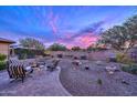 Landscaped backyard with fire pit and seating area at 29308 N 132Nd Ln, Peoria, AZ 85383