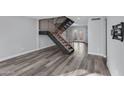 Two-story living room with modern staircase, hardwood flooring, and lots of light at 2968 E Clarendon Ave, Phoenix, AZ 85016