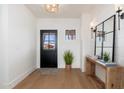 Bright and airy entryway with a black door, wood console table, and large mirrors at 3427 E Campbell Ave, Phoenix, AZ 85018