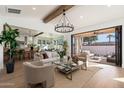 Open concept living room with hardwood floors and a view of the kitchen and backyard at 3427 E Campbell Ave, Phoenix, AZ 85018