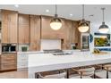 Modern kitchen with white quartz countertops and a stainless steel range at 40715 N Lytham Ct, Phoenix, AZ 85086