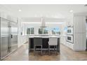 Bright kitchen with stainless steel appliances, white cabinets and an island at 4344 E Desert Crest Dr, Paradise Valley, AZ 85253