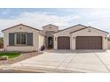 Craftsman style home with two-car garage and landscaped front yard at 5609 W Posse Dr, Eloy, AZ 85131