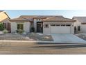 Single story home with a two-car garage and desert landscaping at 7227 E Texas Ebony Dr, Gold Canyon, AZ 85118