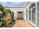 Elegant courtyard entry with a fountain and ornate doors at 7528 N 10Th St, Phoenix, AZ 85020