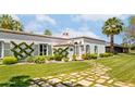 White stucco house with a stone walkway leading to the entrance at 7528 N 10Th St, Phoenix, AZ 85020