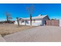 Front view of a white brick house with a gate at 955 N Jay St, Chandler, AZ 85225