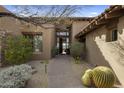 Inviting entryway with courtyard landscaping and a charming pathway at 9909 E Lookout Mountain Dr, Scottsdale, AZ 85262