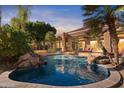 Inviting pool and spa with waterfall feature and spacious patio at 11691 E Turquoise Ave, Scottsdale, AZ 85259