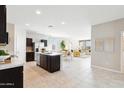 Open concept kitchen with island, looking toward the living room at 1407 W Hess Ave, Coolidge, AZ 85128