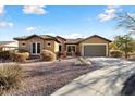 Single-story home with a two-car garage and desert landscaping at 20089 N 263Rd Dr, Buckeye, AZ 85396
