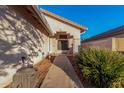 Pathway to the front entrance with landscaping and exterior lighting at 20435 N 39Th Dr, Glendale, AZ 85308