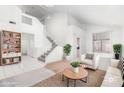 Bright and airy living room with high ceilings, staircase, and ample natural light at 20435 N 39Th Dr, Glendale, AZ 85308