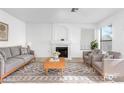 Comfortable living room featuring a fireplace, plush seating, and neutral tones at 20435 N 39Th Dr, Glendale, AZ 85308
