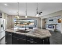 Spacious kitchen with an island, granite countertops, and modern appliances at 22174 E Creekside Dr, Queen Creek, AZ 85142