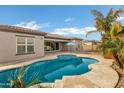 Inviting kidney-shaped pool with a large patio area at 22174 E Creekside Dr, Queen Creek, AZ 85142