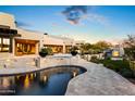 Inviting backyard oasis with a large pool and outdoor fireplace at 22400 N 93Rd St, Scottsdale, AZ 85255