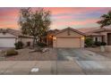 Single story home with two car garage and desert landscaping at 23187 W Lasso Ln, Buckeye, AZ 85326