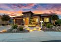 Single-story home with stone accents and beautifully landscaped front yard at 26702 W Sierra Pinta Dr, Buckeye, AZ 85396