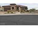 Single-story home with stone accents and beautifully landscaped front yard at 26702 W Sierra Pinta Dr, Buckeye, AZ 85396