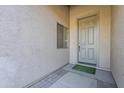 Front door entry with light gray door and small window at 3121 E Hackamore St, Mesa, AZ 85213