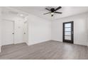 Bright and airy living room featuring wood-look flooring and ceiling fan at 559 N Sirrine St, Mesa, AZ 85201