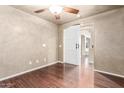 Bright bedroom featuring wood floors and a barn door at 6512 W Eagle Talon Trl, Phoenix, AZ 85083