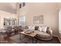 Inviting living room featuring a large, comfortable couch and elegant decor, perfect for relaxation and entertaining guests at 6512 W Eagle Talon Trl, Phoenix, AZ 85083